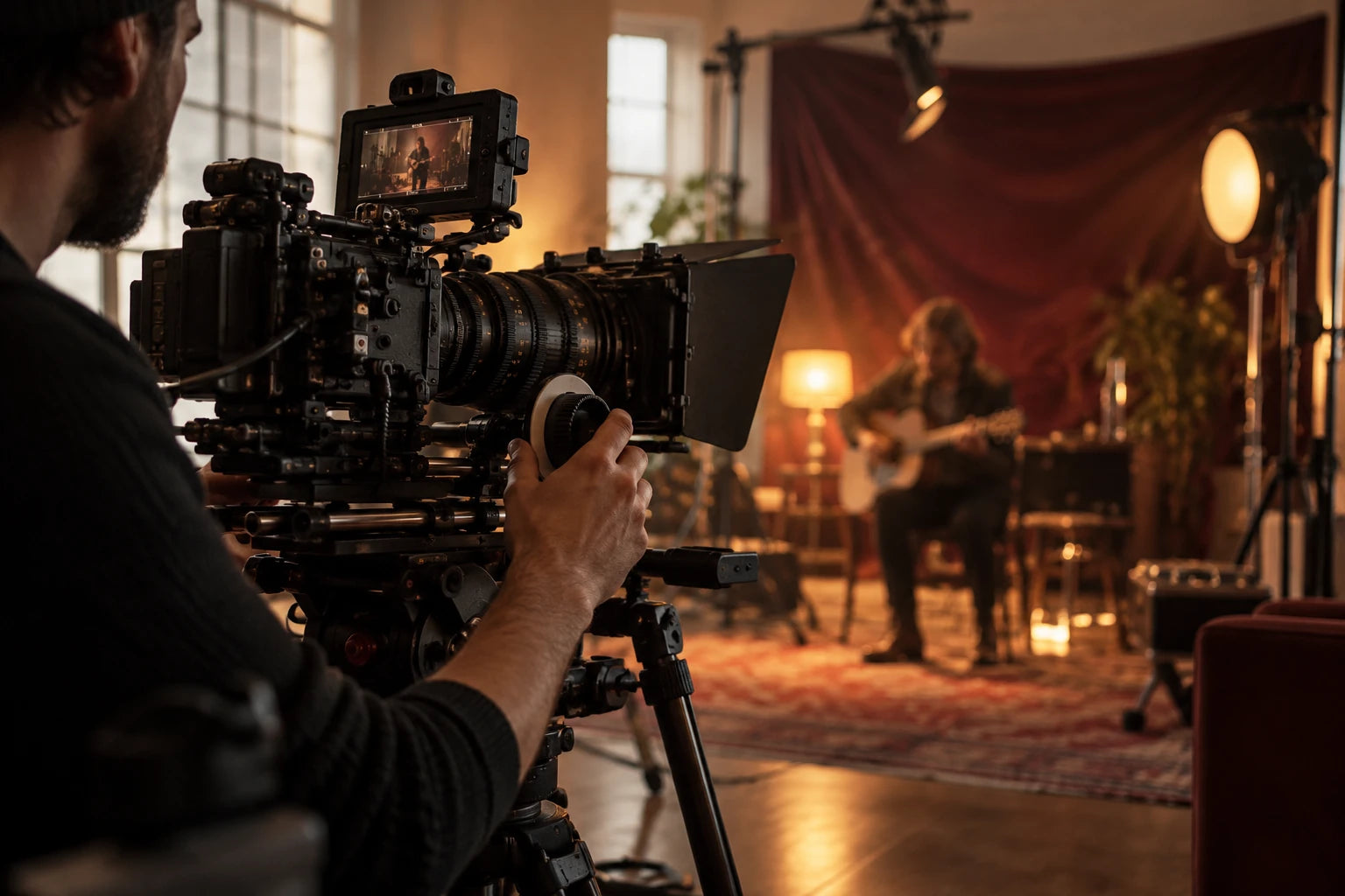 Camera operator filming a performance in a warmly lit production studio